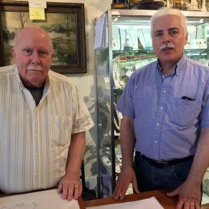 Ted Talbert, left, and Tim Buckowski at the front desk of their antiques business in Wiscasset, Showcase Antiques Gallery. SUZI THAYER/Boothbay Register