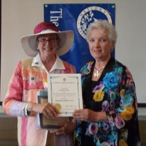 Boothbay Region Garden Club President Mimi O'Neill, left, accepting the NGC First Place Award for the BRGC Yearbook from GCFM President Suzanne Bushnell. Courtesy of Kathleen Marty