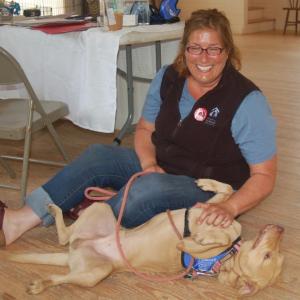 Chris Wolff plays with shelter dog Ginkgo on Saturday. ART MAYERS/Boothbay Register