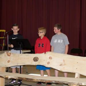 Edgecomb Eddy students, from left, William Clifford, Hunter Brewer and Jake Kelley present the school with a “Buddy Bench” on June 10. Courtesy photo