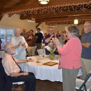Attendees applaud Bud Lewis at Frances Perkins Club award dinner. Bud’s wife Sue is directly behind him. Courtesy photo
