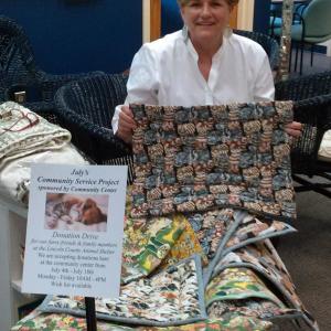 Jane Good, Community Center director, shows the growing collection of kitty and puppy mats made by center volunteers for the Lincoln County Animal Shelter. JANE CARPENTER/Boothbay Register