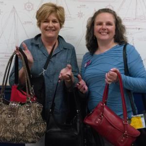 Jane Good, Community Center director (left) and Sarah Sherman, legal advocate for New Hope for Women, show purses that have been filled and are ready to go to domestic violence victims. JANE CARPENTER/ Boothbay Register