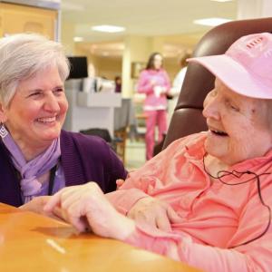 St. Andrews Village volunteer Holly Fulmer with a Gregory Wing resident who is enjoying the iPod she received as part of the Village’s Music and Memory program. Fulmer interviews residents and their families to learn what music residents enjoy most and then gives them iPods stocked with highly personalized selections of music. Courtesy of LincolnHealth