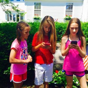 A trio of Pokemon Go players in front of a PokeStop, the war memorial at the Boothbay Harbor Memorial Library. MATTHEW STILPHEN/Boothbay Register