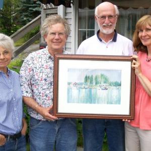 Lynne and John Seitzer, left, of Joy to the Wind Gallery donate artwork to Jerry Homer and Liz Lussier of Boothbay Region Health Care, Inc. The print will be sold to the highest bidder in a silent auction. The print is on display at the Community Center, Meadow Mall, Boothbay Harbor. Courtesy photo