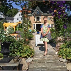 Lucia Droby stands in the courtyard of her Wiscasset business, Carriage House Gardens. SUZI THAYER/Boothbay Register