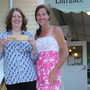 Susan Brackett, left, chairman of the Friends of the Opera House, and Sarah Stedt, treasurer of the Opera House board, display a wooden box made from the former Opera House siding. The boxes will be sold as fundraising items. Courtesy of David Tew