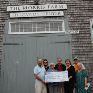 First National Bank presents a donation to Morris Farm. Pictured are, from left, Jack Swanton, treasurer; Marvin Tala, AmeriCorps VISTA volunteer; Merry Fossel, board co-president; Les Fossel, board co-president; Monique McRae, branch manager, First National Bank; Russ Cloutier, store manager; and Pat Cloutier, administrative assistant/programming. Courtesy photo
