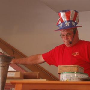 Fire Chief Gerald Gamage rings the bell to open the auction. ART MAYERS/Boothbay Register