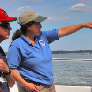 Sarah Gladu, director of Education and Environmental Monitoring at the Damariscotta River Association, will discuss the past and present of oysters in the Damariscotta River at Schooner Cove on Sept. 7. Sarah and the Damariscotta River Association have a long history with Schooner Cove. Sarah is pictured here pointing out a feature of interest during a boat tour with Schooner residents. Courtesy photo
