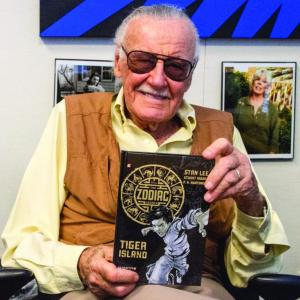 Stan Lee proudly displays his new graphic novel, designed and produced by local artist Dawn Guzzo of Atomic Studios in Boothbay Harbor. Courtesy of PaperCutz
Stan Lee