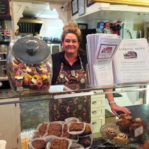 Liz Evans, now a landlubber, in her very busy East Boothbay General Store. SUZI THAYER/Boothbay Register
