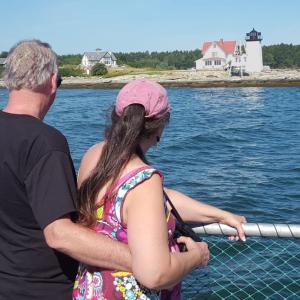 A couple taking in the view of Hendricks Head Light while on a Lighthouse Legends and Lore boat tour earlier this summer. A portion ofthe tour proceeds benefit Burnt Island Light’s restoration. Courtesy of Sally Lobkowicz