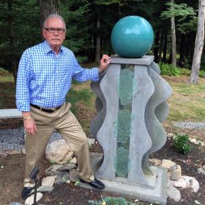 Thomas Cramer stands with one of his sculptures in his backyard in Wiscasset. SUZI THAYER/Boothbay Register