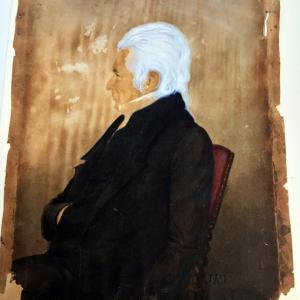 A portrait of a Captain Grovner, done in 1830, was painted on paper that had been wrapped around a wood panel, then framed. The brownish color and grain of the wood had seeped into the paper.
