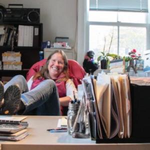 Cathy Sherill takes a rare moment to put her feet up. DIANE DORBIN/Boothbay Register Cathy Sherrill in Opera House Office