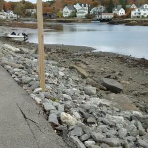 Edge of footbridge parking lot. Tourists climb down boulders to get to the shore. MORGAN CALLAN ROGERS/Boothbay Register