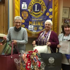 No, these Lions didn’t go shopping! From left, Liz McKim, Mary Tilton, and Karen Nickerson are just holding some of the prizes to be given away in the “Twelve Days of Christmas Raffle.” Courtesy of Joyce Dinnar