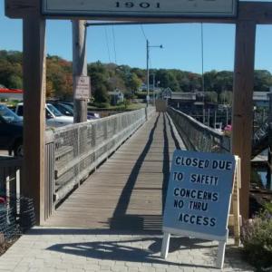 The footbridge is currently blocked with pieces of plywood and signs have been set up to tell pedestrians it is closed for safety concerns. MORGAN CALLAN ROGERS/Boothbay Register