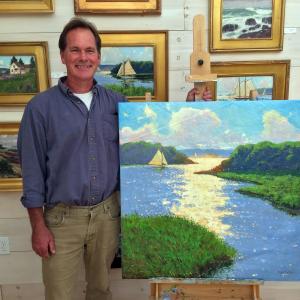Brad Betts with his painting, 'Sunlit Passage,' in his East Boothbay Studio. SUZI THAYER/Boothbay Register
