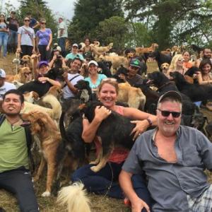 Caroline Canning, center, holding a pup, with her husband Jay, right, at Territorio de Zaguates. Courtesy of Caroline Canning