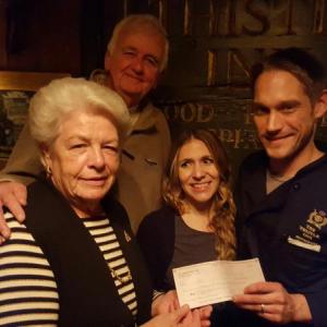 New owners of The Thistle Inn, Dick Reid and Anya Heyl, present a check in amount of $2,480 to Sue Burge, president of the BRCRC board and Bruce Johnson, treasurer. Courtesy photo