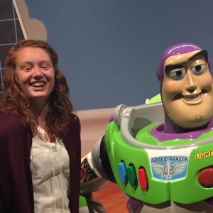 Courtney Brewer stands next to a statue of Buzz Lightyear. Courtesy photo