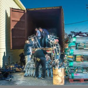 Rotarians pack a truck with crutches, walkers and wheel chairs, collected for the organization, Crutches4Africa, in late November. Courtesy of Steve Demeranville