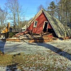 On Tuesday, Dec. 13, people driving through Boothbay Center were seeing something that caused them to slow down to take it in. The late Frank Chamberlain’s house had been demolished, and his huge red barn was toppled over, quickly meeting the same fate as the old white house that had sat there through over 100 Maine winters. Frank, a former longtime Register employee, loved that place, where he shared the house, and the barn where he sharpened knives and saws and carved little wooden animals, with his dog Dammit and his cat, Cat. SUZI THAYER/Boothbay Register