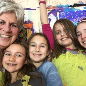 Brady Nickerson, pictured above with some of her art students, finds that creating art can be a vehicle to building self-esteem, confidence and motivation. Courtesy of DRA Brady Nickerson & art students