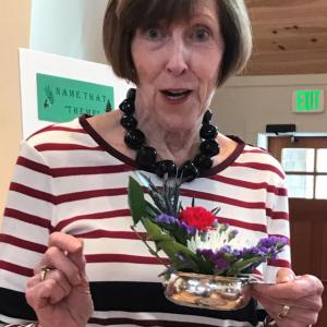 BRGC Horiculture Chair Irene Gerny offers an informal critique of several demure "Flowers for Fun" arrangements at the Feb.8 meeting of the Garden Club. The theme, Silver Bells, emphasized the size and effective use of shiny containers. The design program was followed by a themed potluck luncheon. Courtesy photo