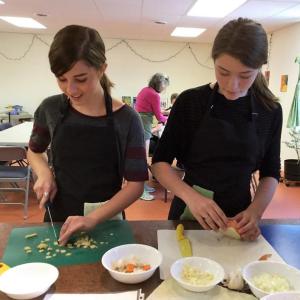 Two students learning kitchen basic 101 subject: dicing. Courtesy of Ellen Durgin
