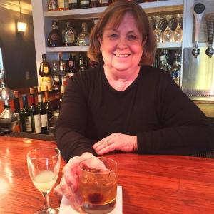 Marilyn Gorneau tends her bar at Little Village Bistro in Wiscasset. SUZI THAYER/Boothbay Register