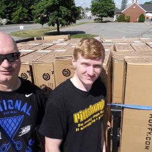 Stuart and Alex Smith get ready to assemble bikes for kids who read voraciously. Courtesy of Stuart Smith