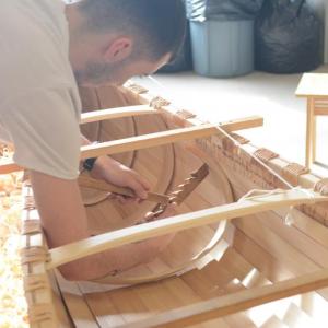 Intern Tobias Francis installs a rib on the Wabanaki birch bark canoe to be launched at the Damariscotta Town Landing on Thursday, April 27. The month-long canoe building project is the result of a partnership between Damariscotta River Association and Lincoln Academy, with support provided by LincolnHealth as well as members of the community. Courtesy photo