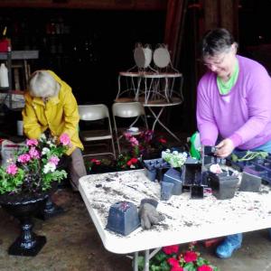 Two volunteer days are scheduled to help get the Boothbay Railway Village ready for the 2017 season. Sign up to help on April 29 or May 13 with tasks like raking leaves or stocking the Museum Store. Pictured here are volunteers Kevin Bowler, right, and Sarah Strouss planting flower boxes during a prior year’s work day. Courtesy photo