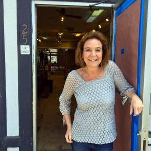 Stacey McLellan in the doorway of her new location for Capers, on Townsend Avenue in Boothbay Harbor. SUZI THAYER/Boothbay Register