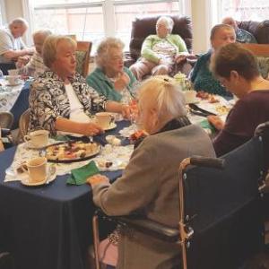 Gregory Wing volunteers and residents enjoy tea and refreshments on April 17 at the Gregory Wing. Courtesy of Barbara Marr