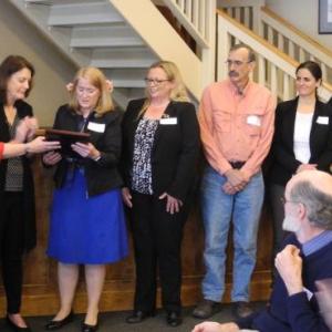 The Rev. Sarah Foulger accepts the award from Barbara Reinertsen, far left in red, and Connie Jones, United Way Board Chair, with other members of the coalition. Courtesy photo