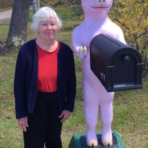 Miss Pig is back on her stand along Route 27 in Boothbay and here to welcome her return last week was one of her overseers, Joan Rittall. Courtesy of Debrah Yale