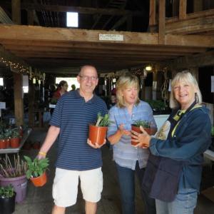 Morris Farm volunteer Linda Pope, right, assists Peter and Terri Wells with their purchases at last year’s plant sale. Courtesy photo