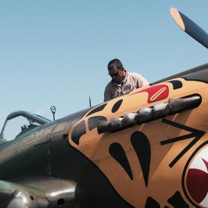 Texas Flying Legends pilot Bernie Vasquez tends a P40 fighter plane at Wiscasset Municipal Airport on July 28, 2015. File photo