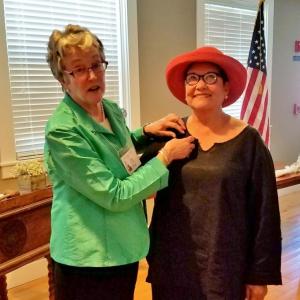 Mimi O’Neill, left, outgoing president, pins new Boothbay Region Garden Club president, Claire Tomlin. Courtesy photo