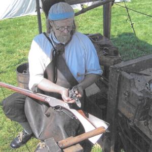 Blacksmith Jeff Miller working at his temporary forge. This type of forge was used by a blacksmith before he established his shop. Courtesy photo