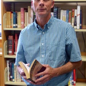 Mark Gorey poses with a collection of William Faulkner short stories, “Go Down, Moses.” JOSEPH CHARPENTIER/Boothbay Register