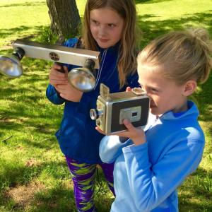 Harriet and Piper McKane of Wiscasset take aim with vintage movie equipment. Courtesy photo