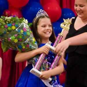 The first Miss Windjammer, Emerson Harris, center, receives her trophy, crown and bouquet from pageant coordinator Emily Mirabile in 2016. BILL PEARSON/Boothbay Register
