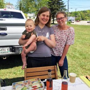 Carrie Braman with her 9-month-old son, Quinn, and employee Cathy Choplick, at the Boothbay Farmers Market on June 8. SUZI THAYER/Boothbay Register