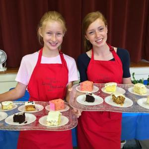 Erin Russell, left, and her sister Molly, serve cake at the Southport Country Fair and Lobster Roll Luncheon on July 19. SUZI THAYER/Boothbay Register